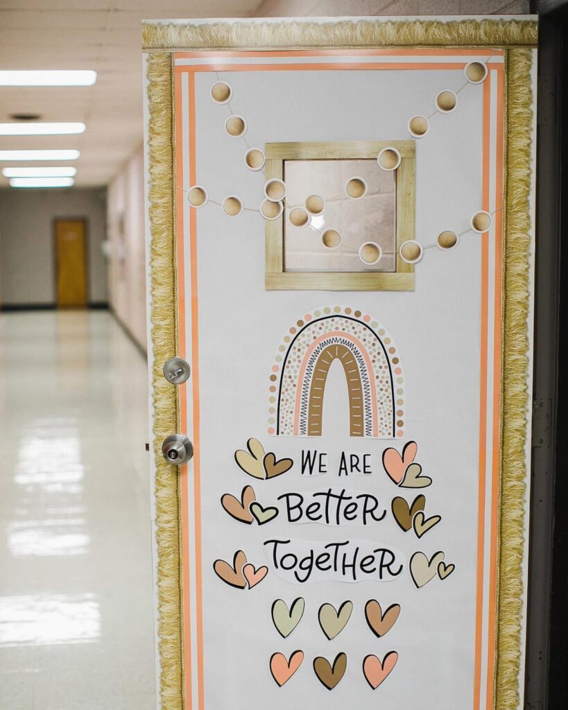 Decorated classroom door featuring a boho rainbow, hearts, and positive motivational text.