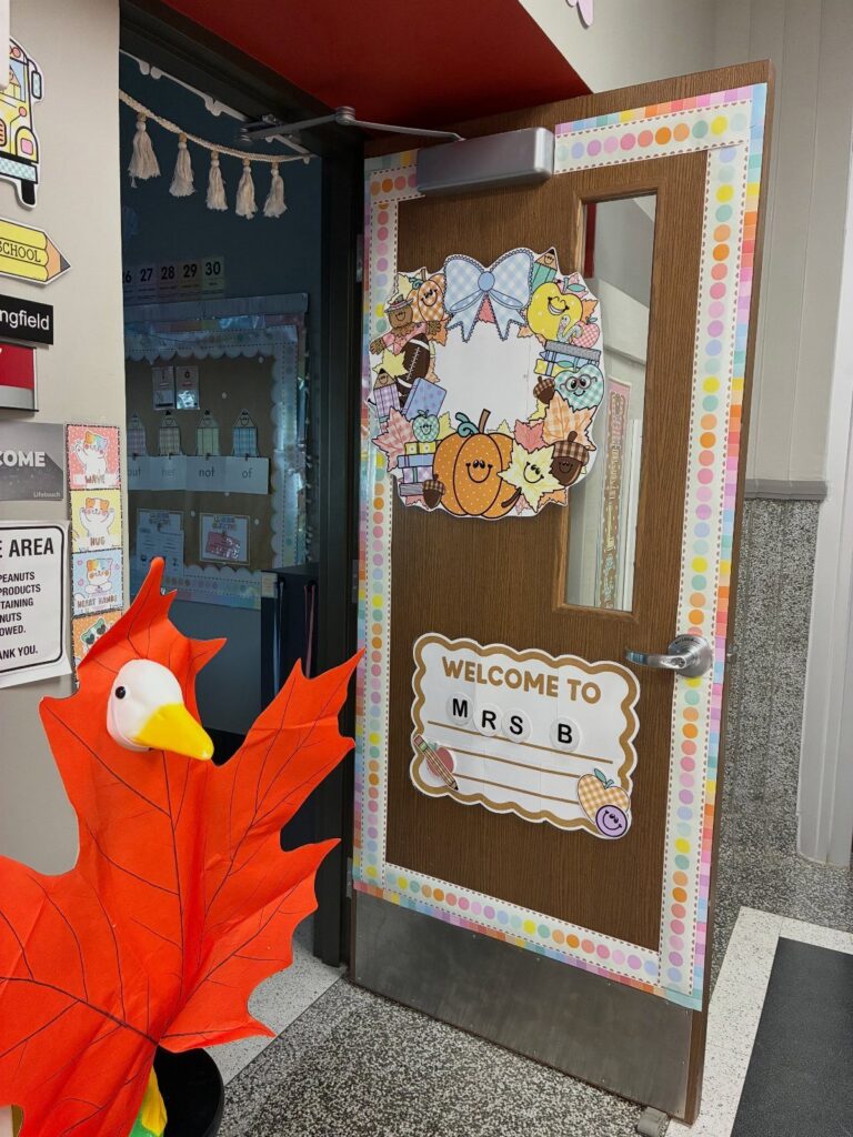 Decorated classroom door with a fall wreath and welcome sign for Mrs. B