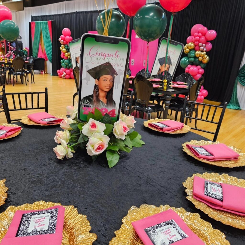 Graduation party centerpiece with a graduate's photo cutout and pink and white roses.