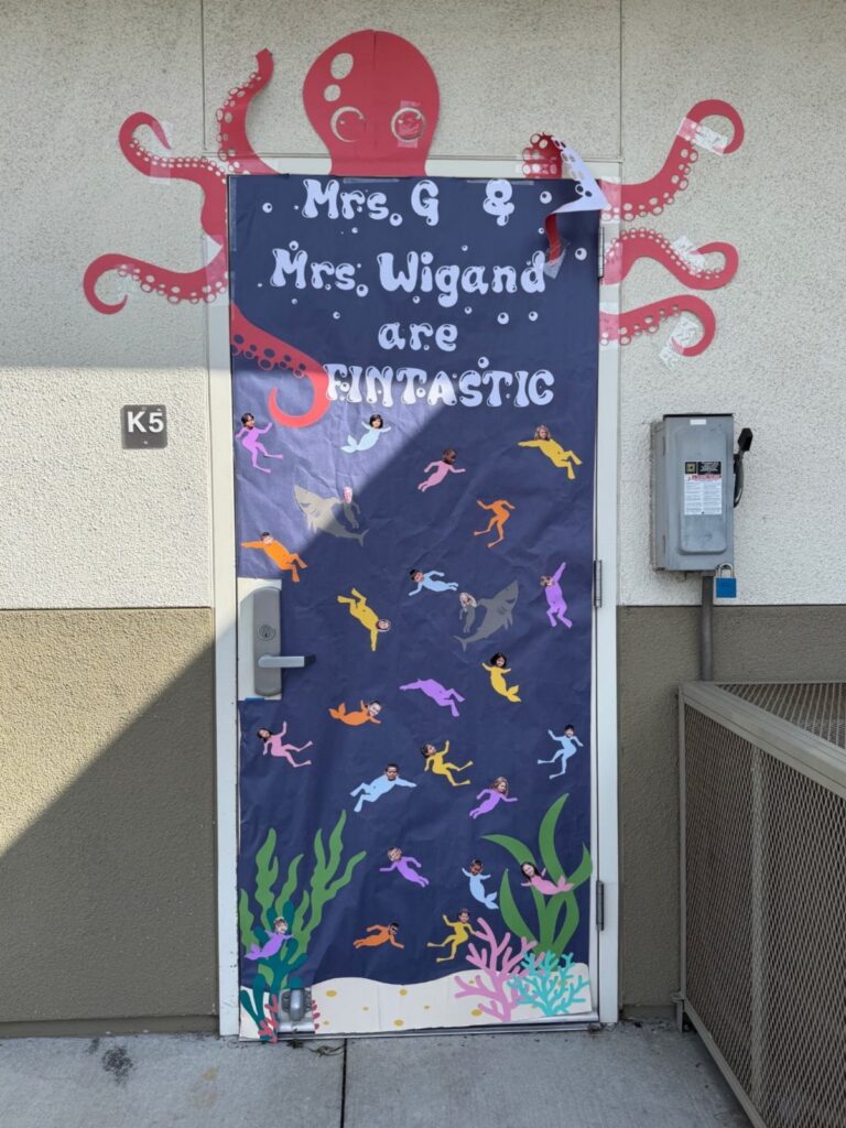 Underwater themed classroom door decoration with colorful fish and a red octopus mural.