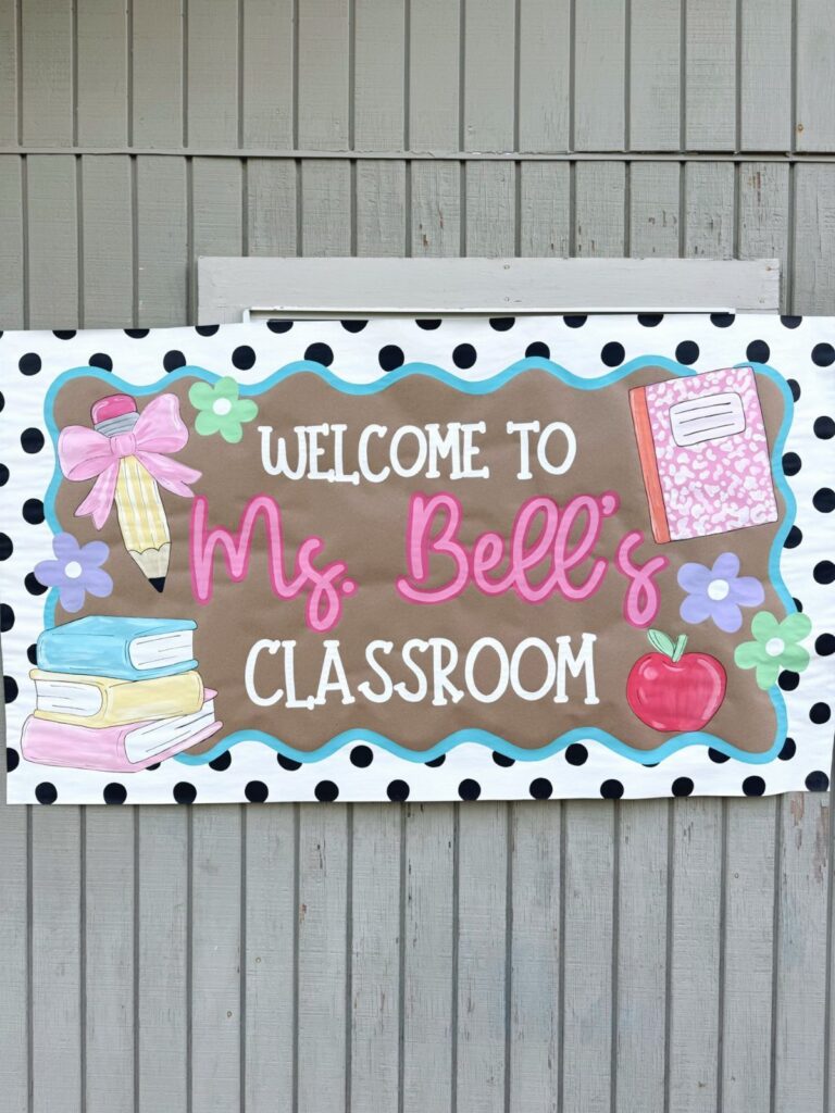 Classroom welcome banner for Ms. Bell with school-themed illustrations on a wooden wall